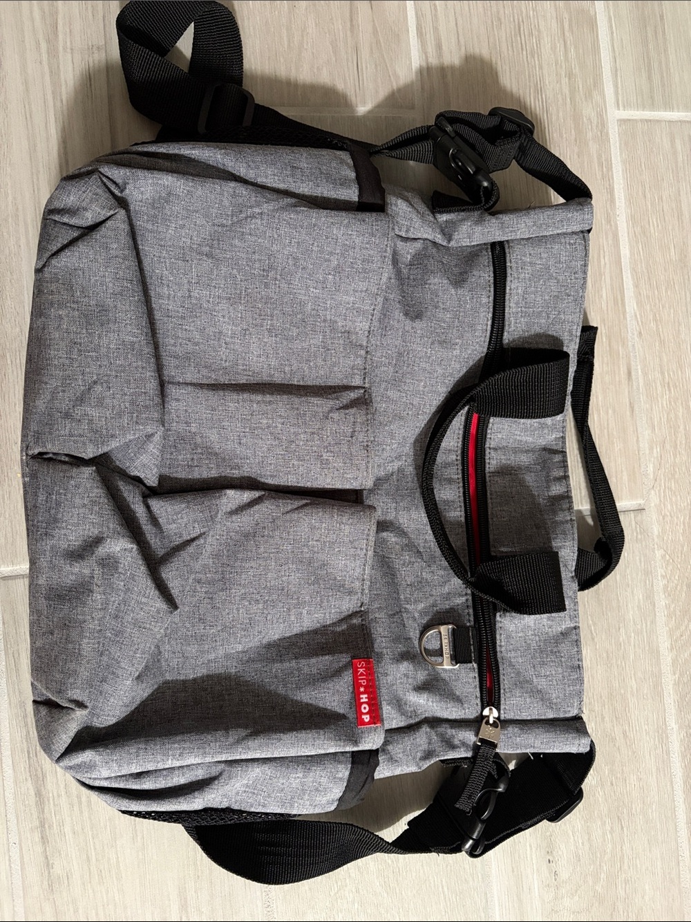 Skip Hop Gray Diaper Bag with Black Straps and Red Zip Accent